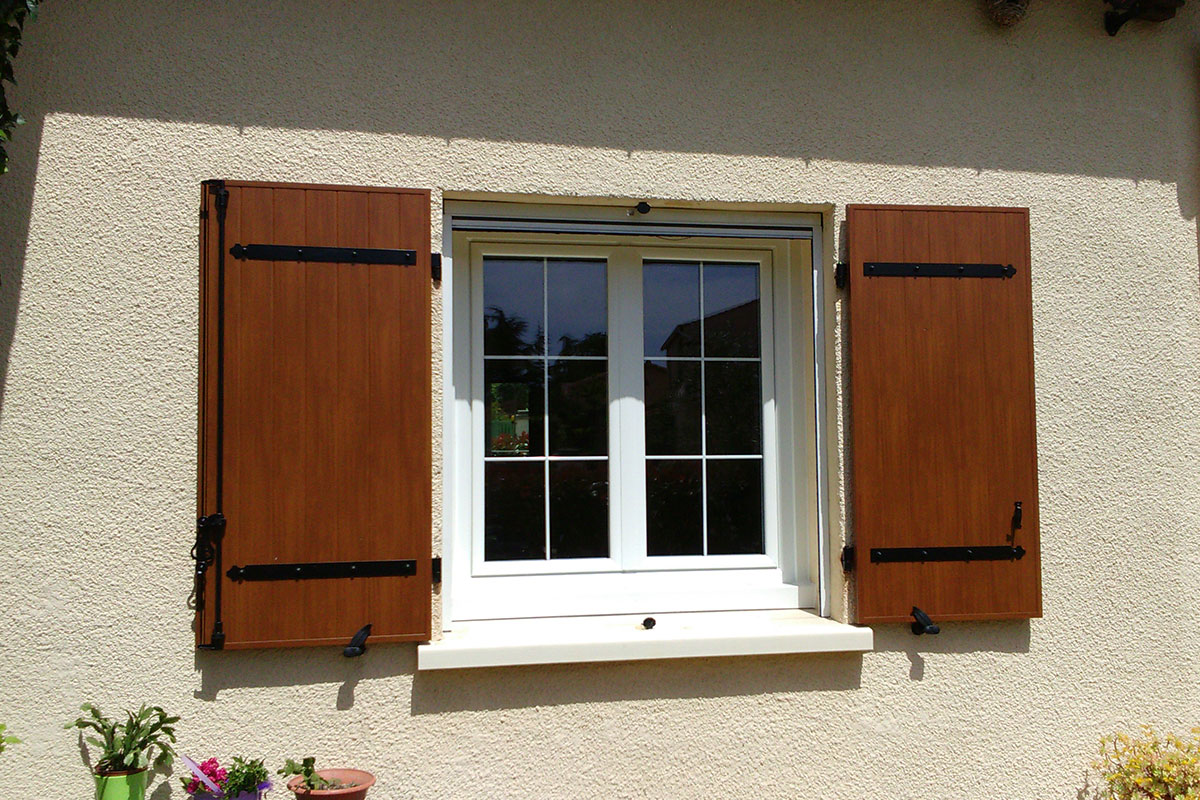 Fenêtre PVC avec petits bois incorporés dans le vitrage et volets battants en aluminium imitation bois
